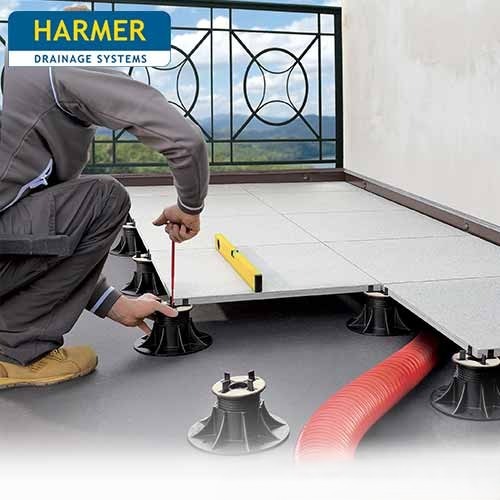 Modulock Raised Paving and Decking Support system from Harmer being fitted