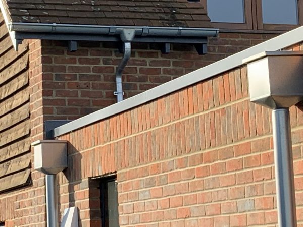 ZM Coated Galv Steel Hoppers and downpipes on a flat roof extension