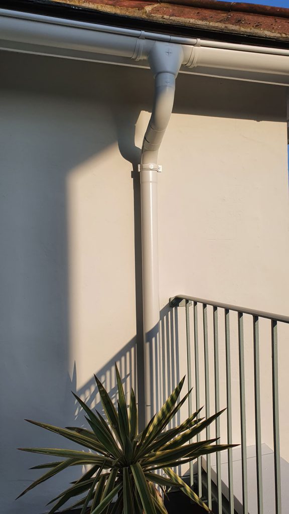 Grey White Colour coated Glav Steel Gutters and Downpipes on a terrace balcony