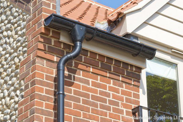 Black Colour Coated Galv Steel gutters and downpipes on a luxury housing development