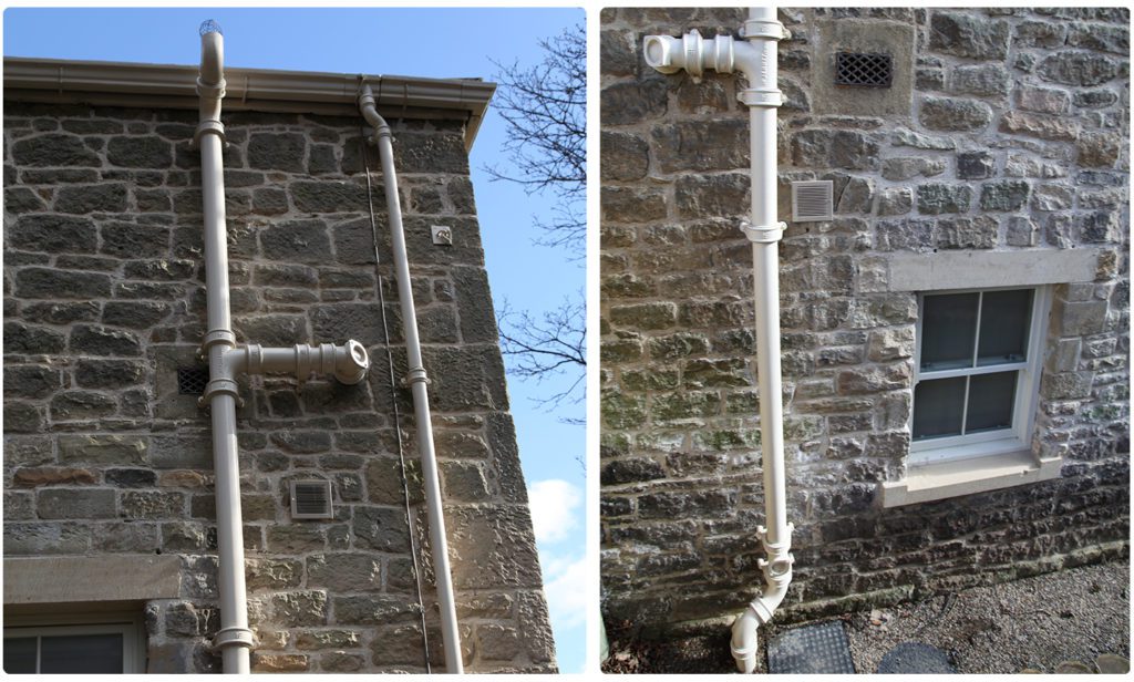 Parl White simpleFIT cast Iron Soil pipes in situ on stone built building. You can see the 'eared' collars - the traditional way to attach cast iron soil pipe sot he building.