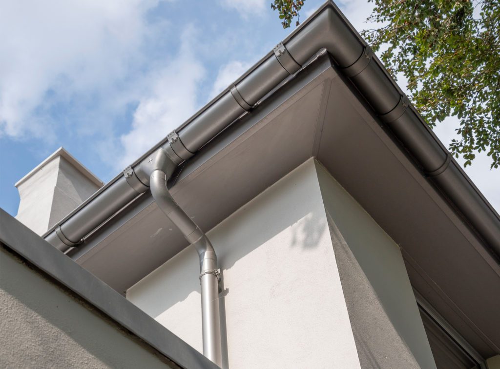 Image 1. Grey Aluminium colour coated Galvanised Steel guttering and downpipe on a build by K J Kilford Carpentry Contractors Limited in Christchurch, Dorset.